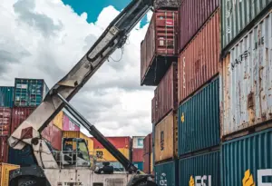 Reach stacker handling a container in a carrier yard