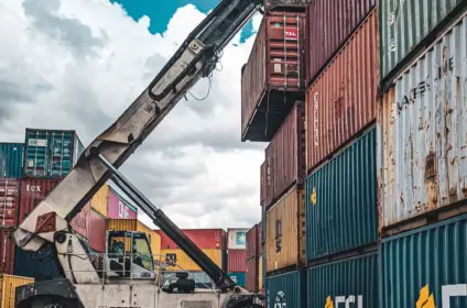 Reach stacker handling a container in a carrier yard