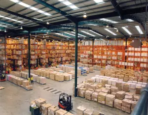 Inland warehouse interior with pallet racking and forklifts